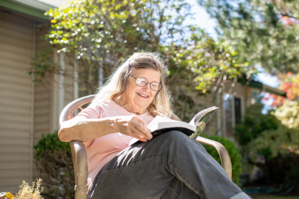Senior Living Resident Reading Outdoors