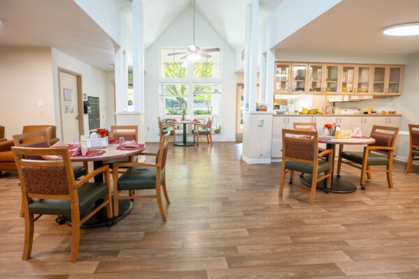 Inviting Memory Care Dining Room with vaulted ceilings and family kitchen photographed by Keynote Creative in Seattle, WA